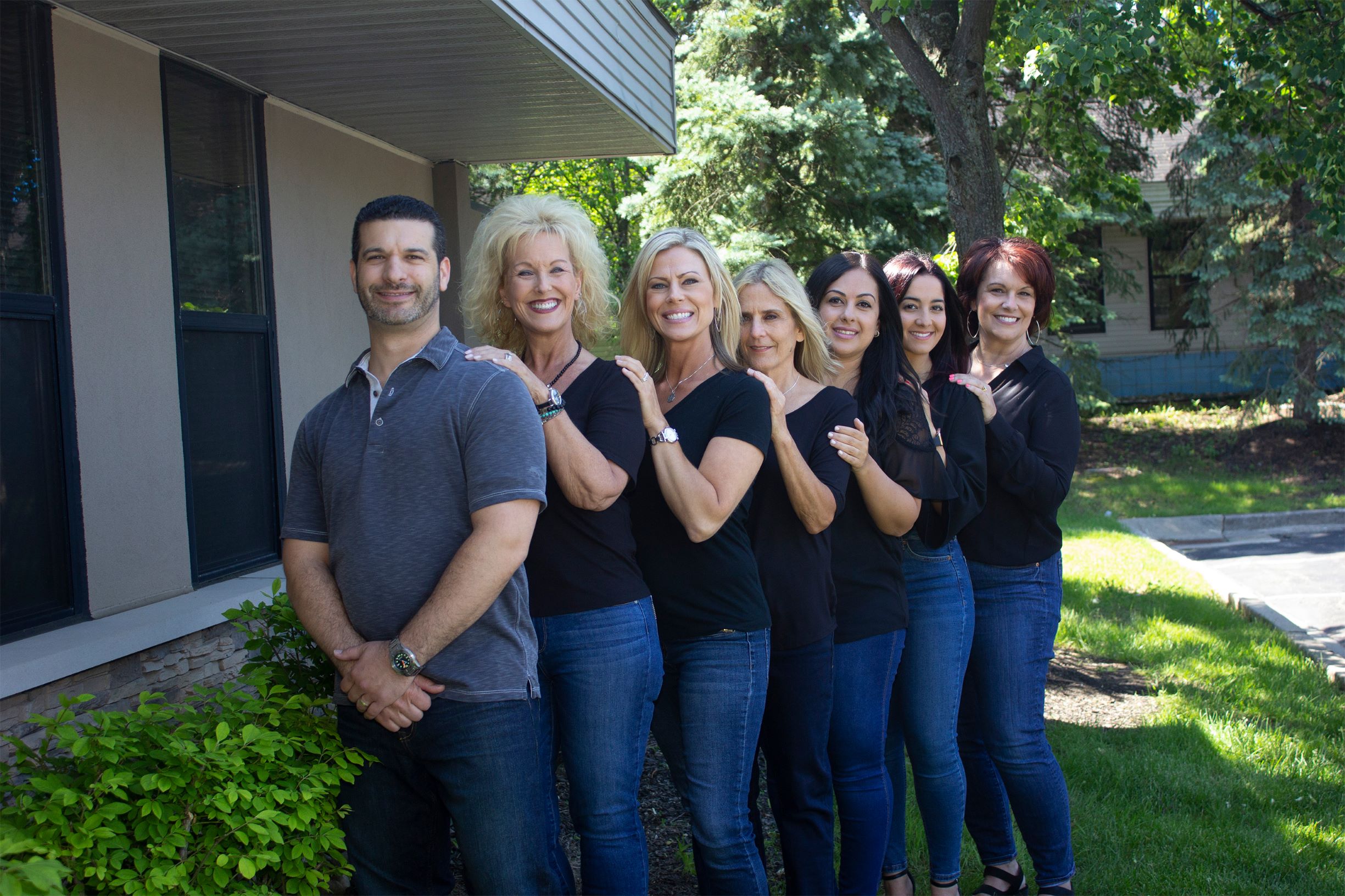 Dentist Adam Fienman and staff pose for a photo outside of the West Bloomfield dental office. Patients are always safe with Dr.Fienman, Best Dentist in Metro Detroit.