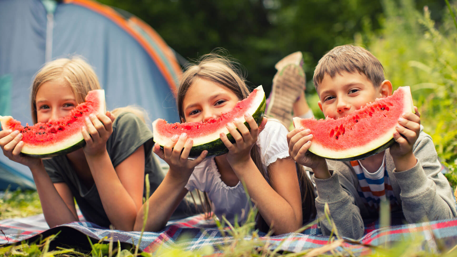 Kid dental tips for camp and summer sports with kids at camp with watermelon. We offer invisalign dentistry, remineralizing, and more!